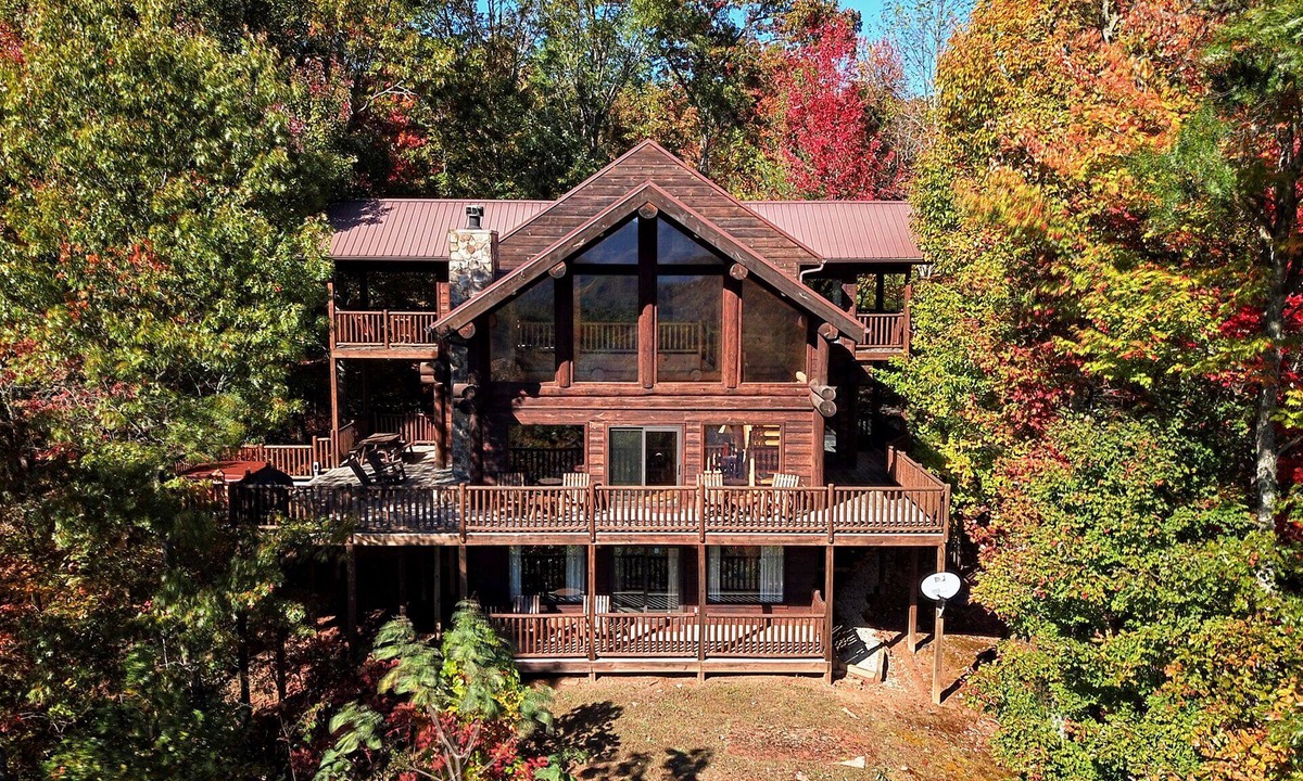 Almond Cabin | Antler Ridge - a stunning log cabin with spacious deck equipped with outdoor fireplace, hot tub, and scenic mountain views!