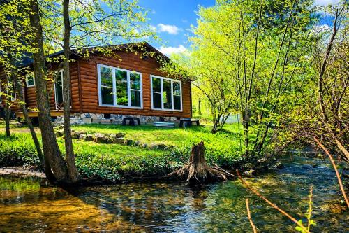 Traverse City House | Creekside Hot Tub-Walk to Beach-Uniquely Northern
