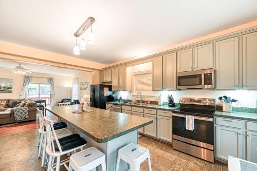Orange House | Lakeside retreat with a firepit, dock, deck, hot tub, pool table - dog friendly