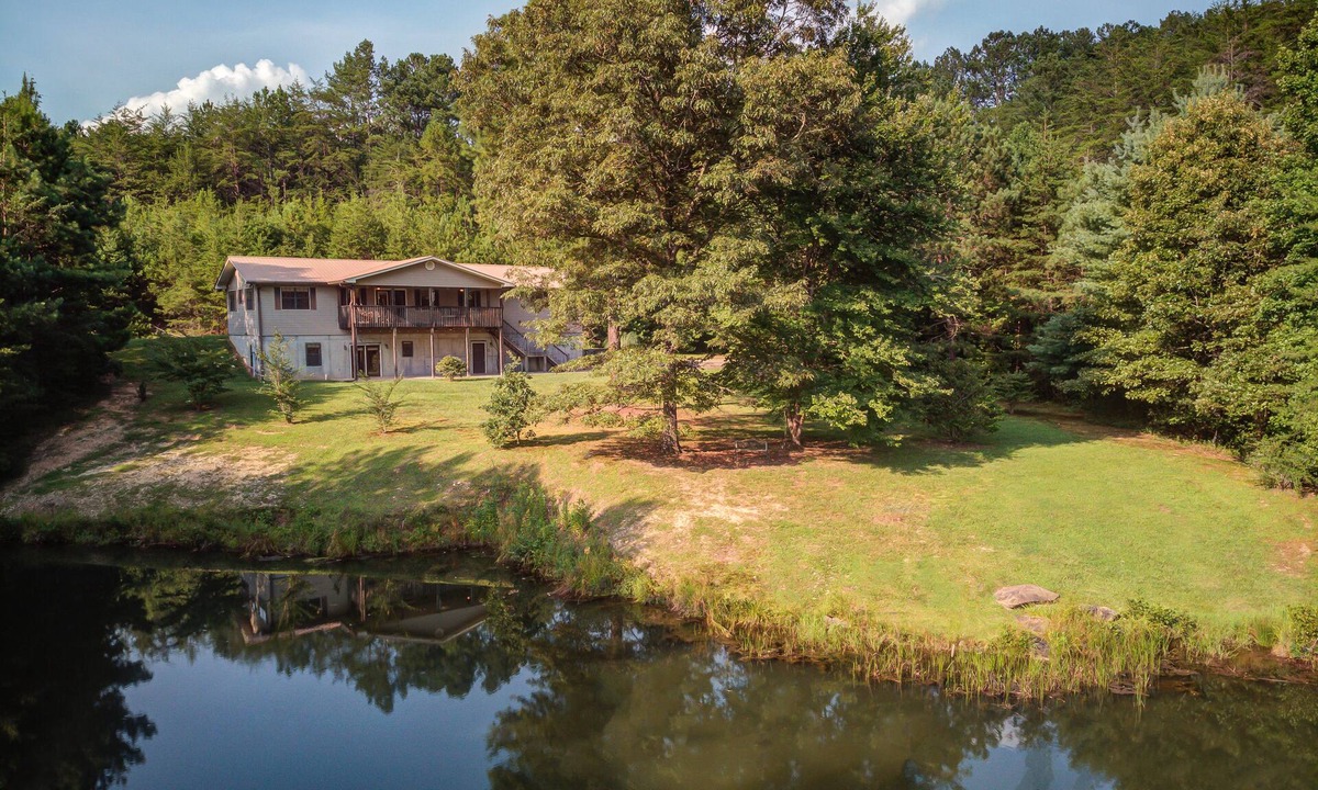 Copperhill Cabin | Pond-front cabin with private hot tub, fireplaces, furnished deck, & game room