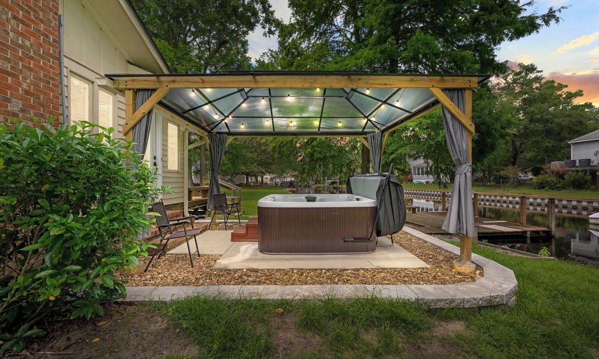 River Bend House | Quiet Riverfront 3BR/2BA house with Spa, Dock, and Golf Carts