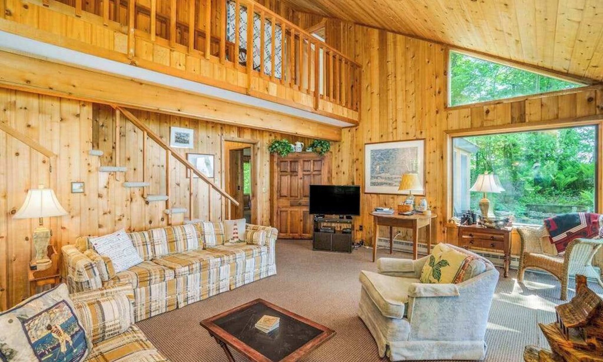 Lake Township House | Rustic dream-home w/lake views, wraparound deck, & wood-burning fireplace