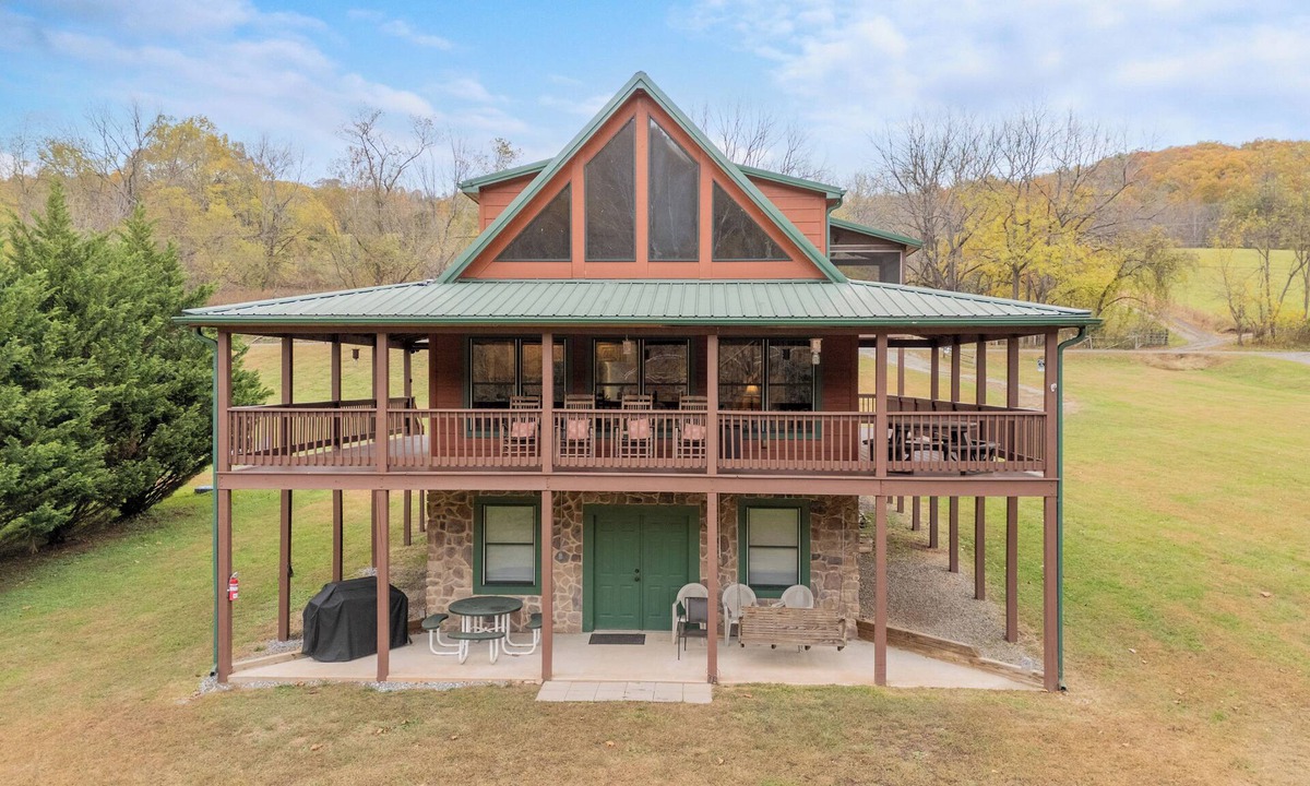 Draper House | Sunny riverside cabin with loft views, big deck, game room, porches, and open lawn.