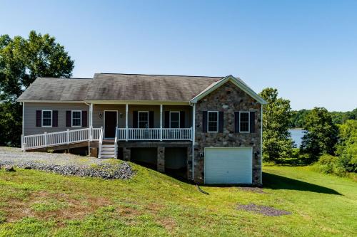 Orange House | Two-story, lakefront getaway with dock, beach, grill, 2 kayaks, 2 canoes, AC