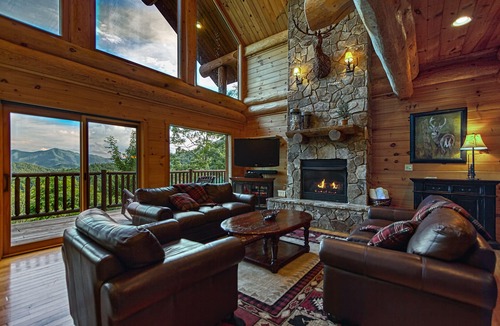 Almond Cabin | Antler Ridge - a stunning log cabin with spacious deck equipped with outdoor fireplace, hot tub, and scenic mountain views!