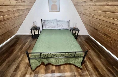 Albertville Cabin | Bass Luxury Tiny Cabin on Lake with Jump Houses
