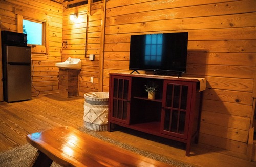 Hattieville Cabin | Charming cabin with loft, porch swing, AC, and WiFi on 295-acre peaceful retreat