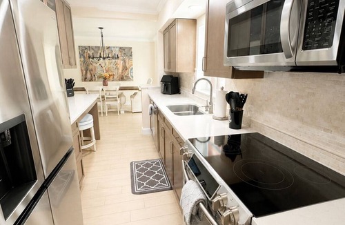 Tropic Palms House | Coastal retreat with heated saltwater pool & spa in prime Delray Beach.