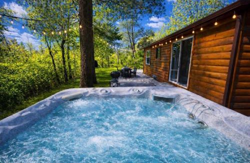 Traverse City House | Creekside Hot Tub-Walk to Beach-Uniquely Northern