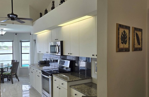 Pelican House | Escape to 80 ft Waterfront Luxury, Private Pier, Heated Pool, Jacuzzi, Bicycles!