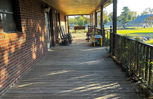 Oxford House | Escape to Serenity: Cozy Ranch Style Home with Charming Wrap-Around Porch.