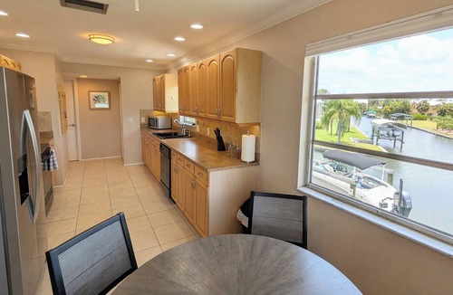 Estero Bay Shores House | Gulf Access Canal 3 BR Home: Bring your Boat, Kayaks, Game Room, Gym, Hot Tub
