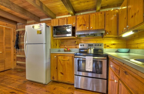 Dial Cabin | Indulge in "Just One More Night", a pet-friendly creekfront retreat boasting a spacious outdoor deck, hot tub, firepit, and WiFi