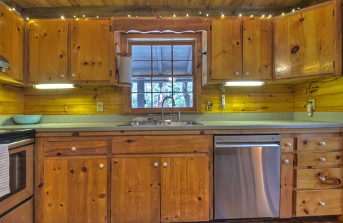 Dial Cabin | Indulge in "Just One More Night", a pet-friendly creekfront retreat boasting a spacious outdoor deck, hot tub, firepit, and WiFi