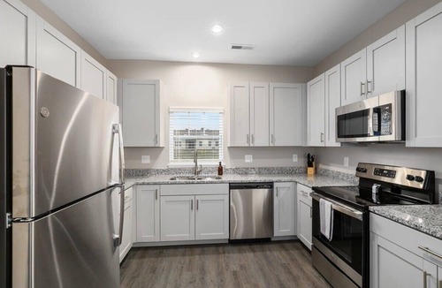 Grandville Apartment | Modern 8BR 8BA Condo w Garage and Patio
