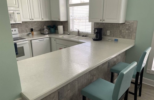 Central Myrtle Beach Condo | Pet Friendly 2 BR - Golf Course View! 1st Floor with screen door off back porch