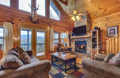Gatlinburg Cabin | Pet-friendly retreat with tree-top views, a hot tub + an arcade loft!