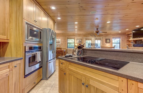 Copperhill Cabin | Pond-front cabin with private hot tub, fireplaces, furnished deck, & game room