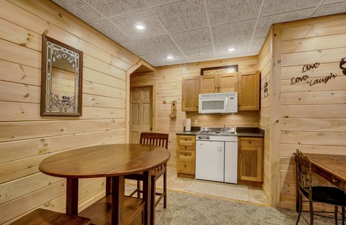 Copperhill Cabin | Pond-front cabin with private hot tub, fireplaces, furnished deck, & game room