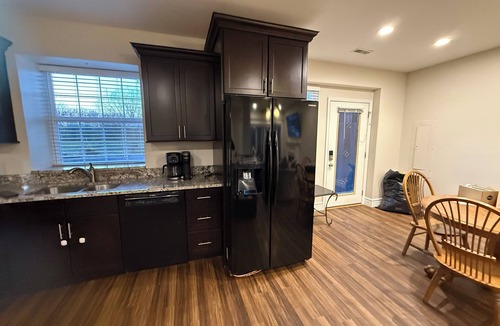 Caseyville Apartment | Private one-bedroom suite with king bed, walk-in closet, and ensuite bath featuring double vanity and safety grab bars. Enjoy serene pond views from your patio, full kitchen, and dedicated workspace for a comfortable stay.