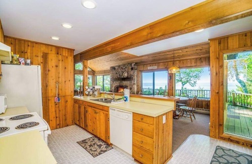 Lake Township House | Rustic dream-home w/lake views, wraparound deck, & wood-burning fireplace