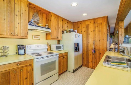 Lake Township House | Rustic dream-home w/lake views, wraparound deck, & wood-burning fireplace
