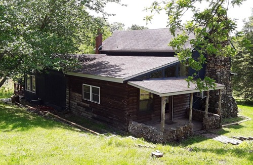 St. James House | Spacious but cozy farmstead lodge has stone fireplace and sleeping for 9 to 10