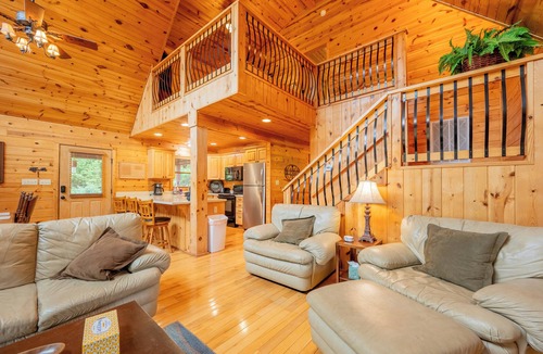 Draper House | Sunny riverside cabin with loft views, big deck, game room, porches, and open lawn.