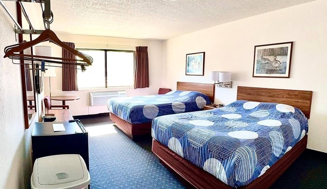Accessible ADA room with two queen beds, private bathroom, mini fridge, and single-serve coffee maker.