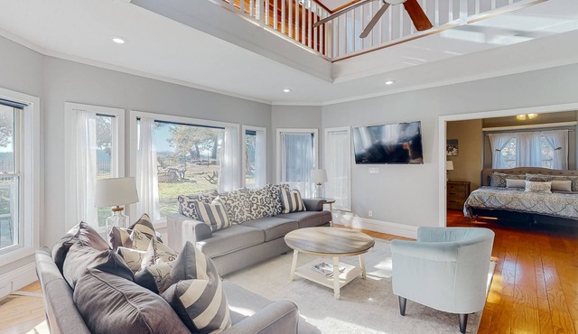 Gorgeous water view home with a fireplace, outdoor space & central AC