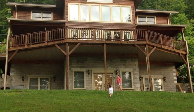 Large lakefront retreat with huge dock, sun deck, kayaks and hot tub;
