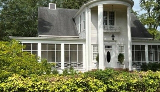 Relax sitting on wrap around porch in this Historic Mansion