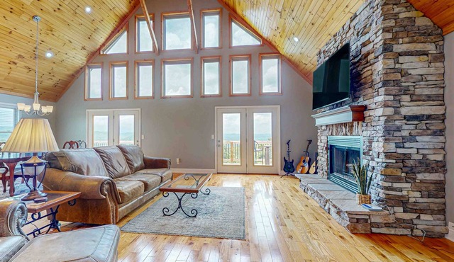 Scenic lakeview retreat with wraparound deck, vaulted ceilings & game room