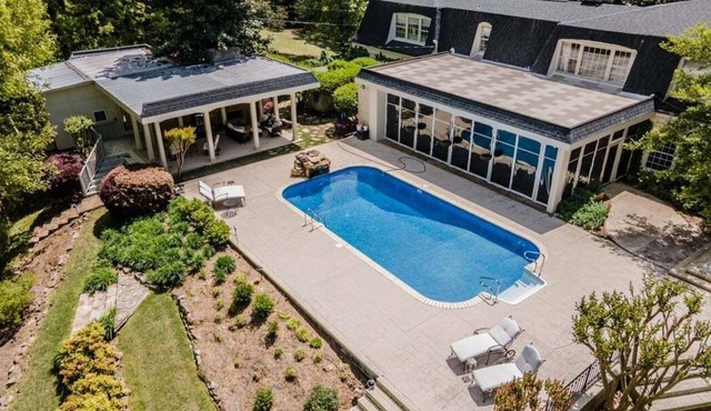 Spacious 5BR estate with Jacuzzi, pool, patio, and full kitchen.