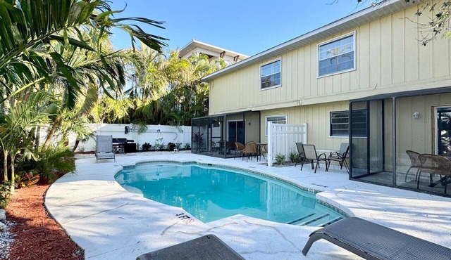 Walk to the Beach and More from this Fully Renovated Unit W/Heated Pool